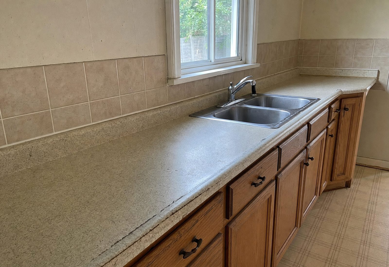 Dated beige laminate kitchen countertop before resurfacing